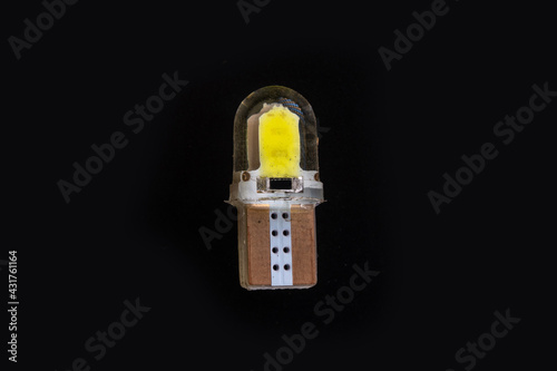 Car light bulb emitting diode, accessories and components for electronics vehicles. copy space. Black background close-up. 12V T10 photo