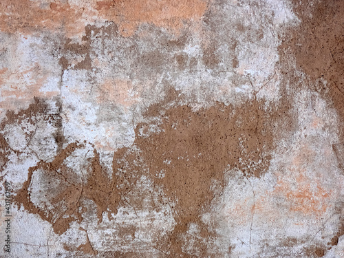 Peeling and cracked wall of an old house, grunge background in dark tone