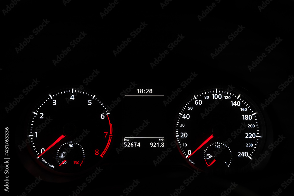 Car speedometer dashboard lit up in the dark. Engine start, transportation gas tank gauge concepts