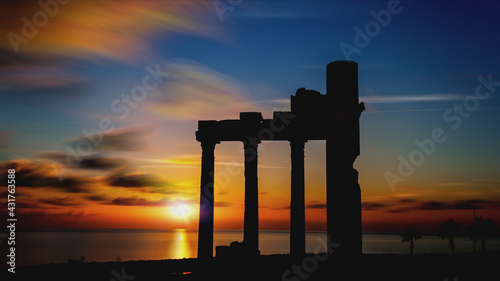 Beautiful sunset sky with antique ruins of columns, twilight sky background.