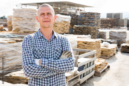 Portrait of a man seller of building materials at an open-air site