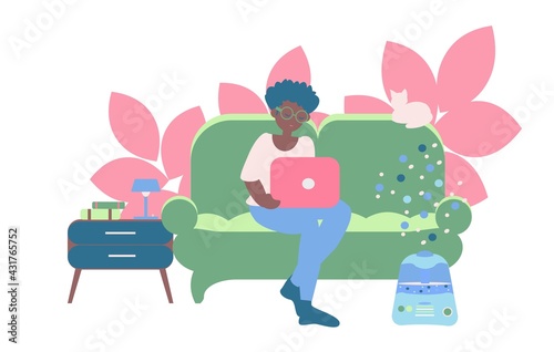 Freelancer working at home Young african american women seat on sofa with note book and humidifier near nightstand