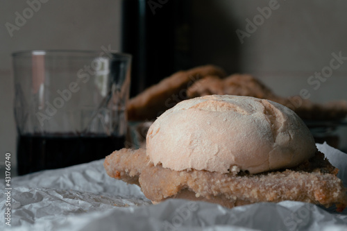 italian fast food, sandwich with milaese style cutlet with a red wine glass 