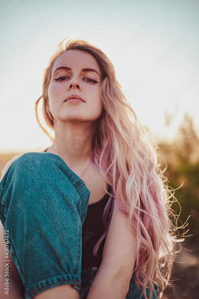 girl in a field on a white chair in jeans, fashion photo girl in a field on a white chair in jeans, fashion photo