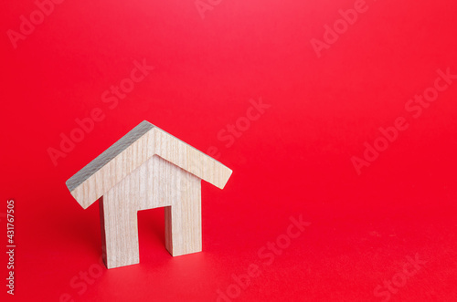 Wooden house on a red background. Buying and selling. Housing, realtor services. Renovation and home improvement. Building maintenance. Rent of apartments and houses. Mortgage loan.