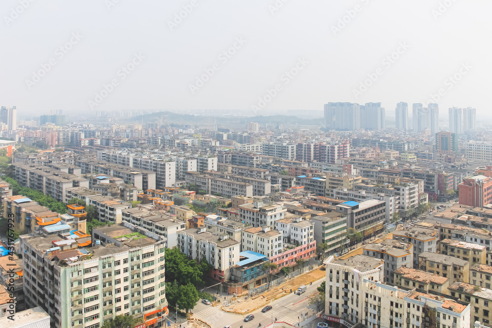 Aerial cityscape skyline view of urban sprawl with air pollution and smog in Huadu District suburb of Baiyun Guangzhou, China.