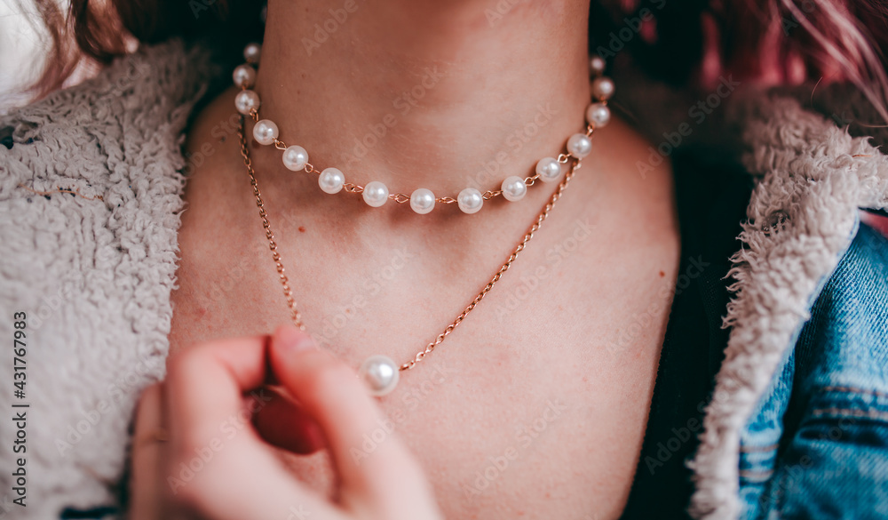 pearl necklace around the girl's neck