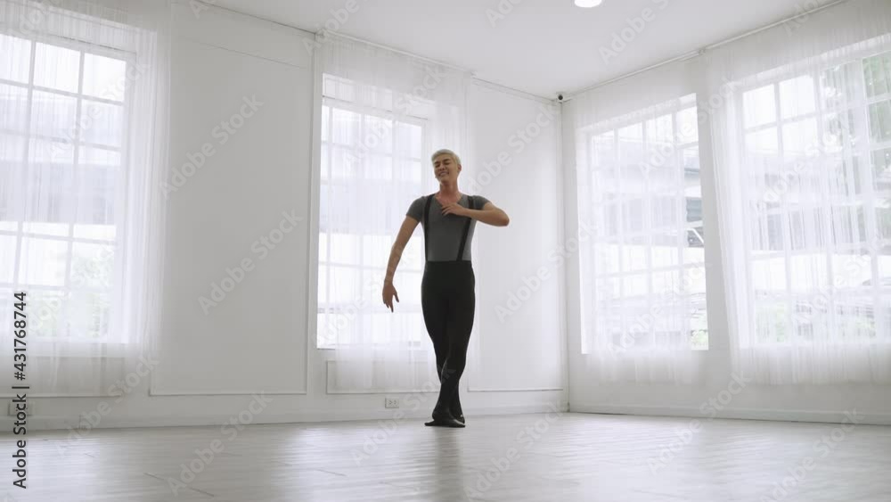 young Asian ballet dancer practicing in a room alone.
