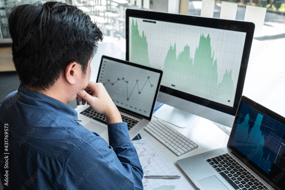 Businessman investor working in traders marketing and planning and analyzing pointing on the stock chart data presented and deal on a stock exchange to business profit