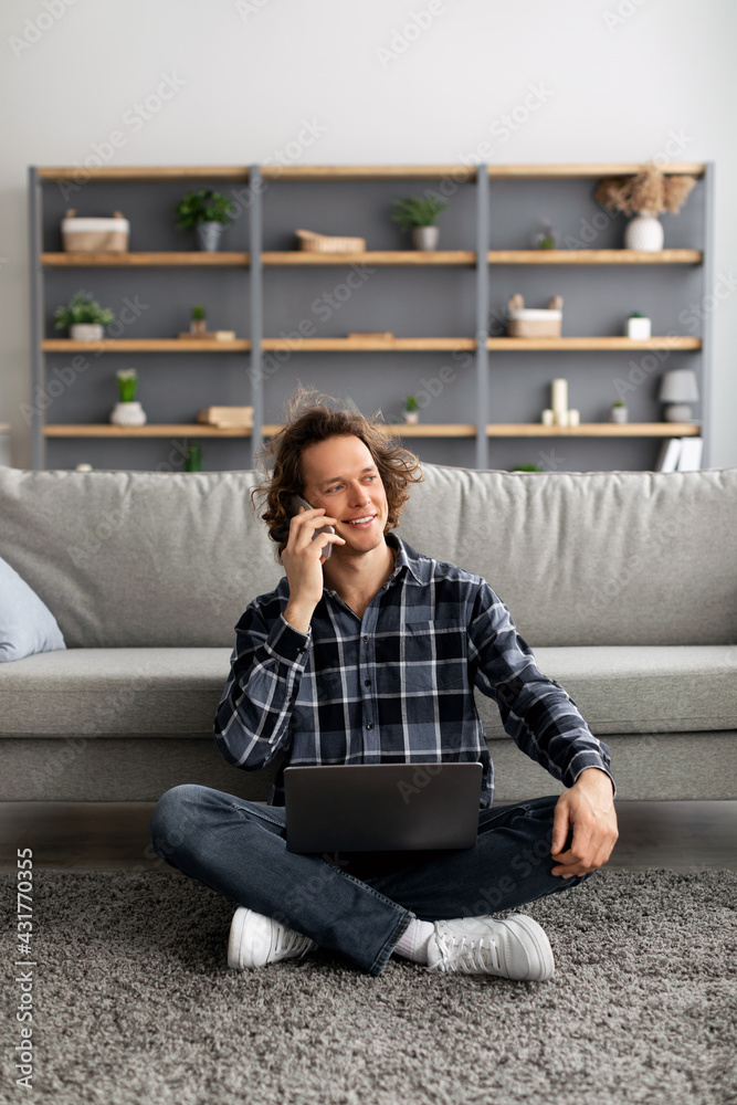 Male Freelancer With Laptop Talking On Cellphone Sitting At Home Male Freelancer With Laptop Talking On Cellphone Sitting At Home