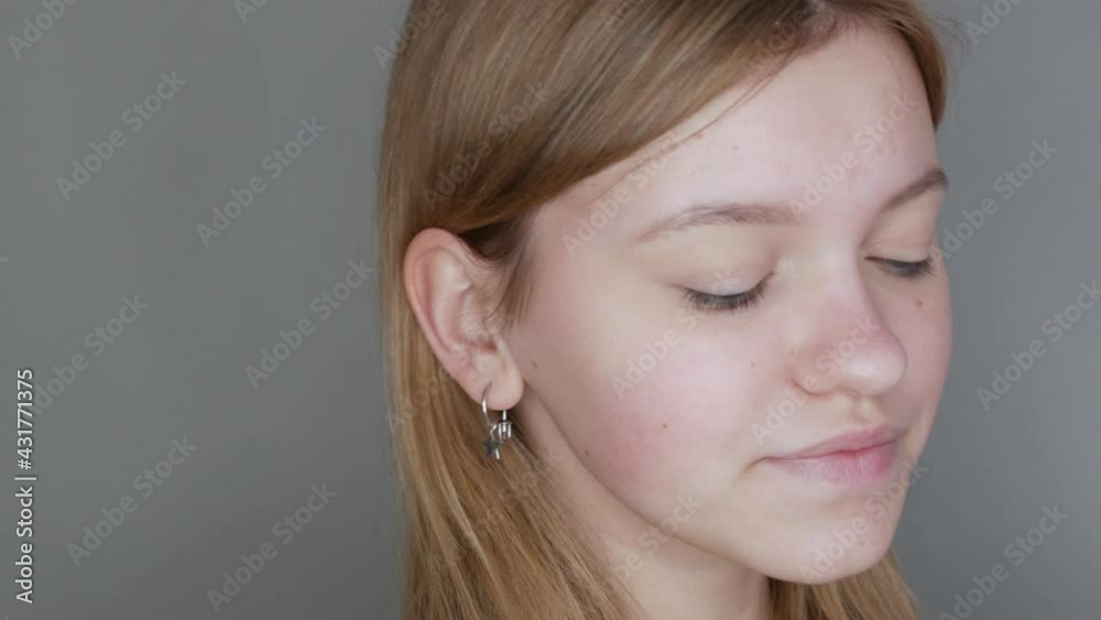 Beautiful young girl without makeup with a natural appearance posing in front of the camera in the studio Beautiful young girl without makeup with a natural appearance posing in front of the camera in the studio