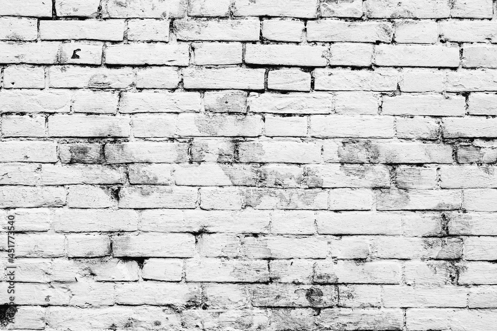 Texture of a brick wall with cracks and scratches which can be used as a background Texture of a brick wall with cracks and scratches which can be used as a background