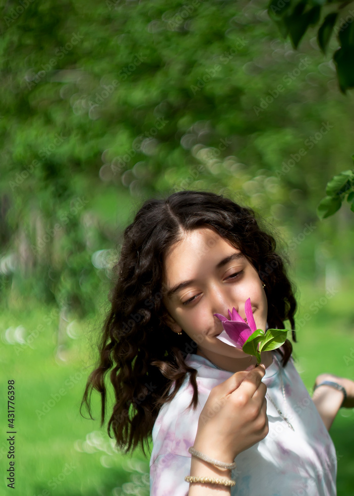 Little girl enjoys the smell of flowers in the meadow Little girl enjoys the smell of flowers in the meadow