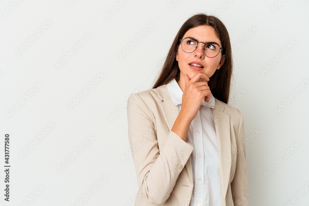 Young business caucasian woman isolated on white background looking sideways with doubtful and skeptical expression. Young business caucasian woman isolated on white background looking sideways with doubtful and skeptical expression.