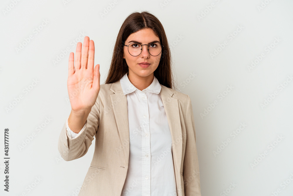 Young business caucasian woman isolated on white background standing with outstretched hand showing stop sign, preventing you.