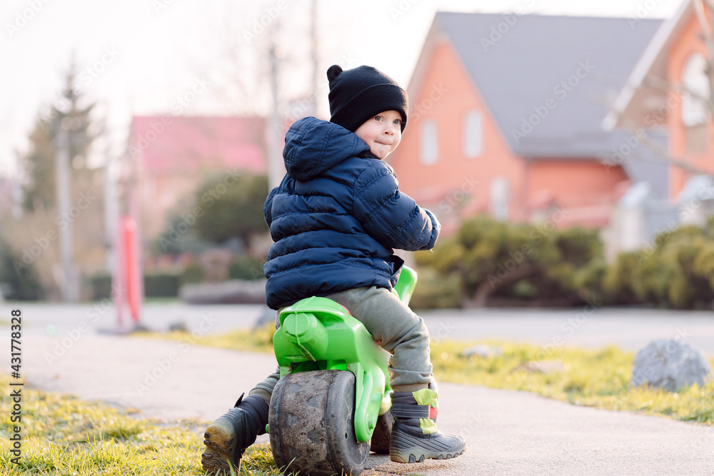 boy riding a bike on the street. Learning to ride a bike concept boy riding a bike on the street. Learning to ride a bike concept
