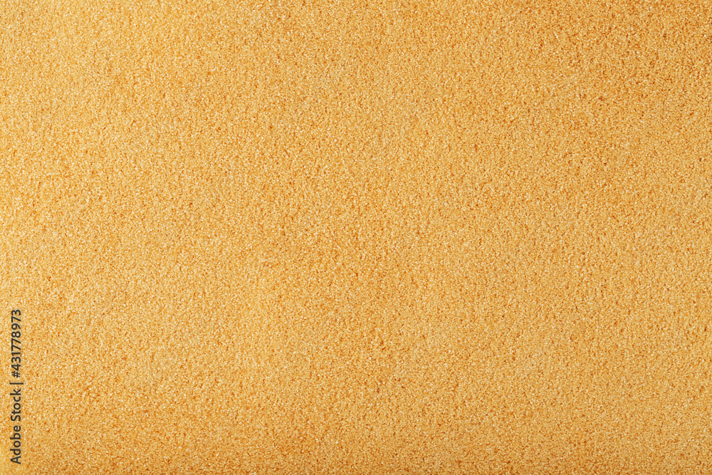Texture of golden sand on the beach with a solid background in full screen