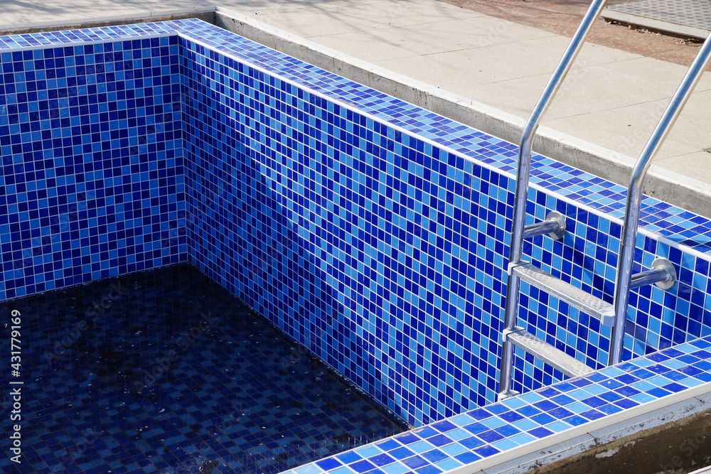 Fototapeta premium empty pool without water with stairs on a sunny day