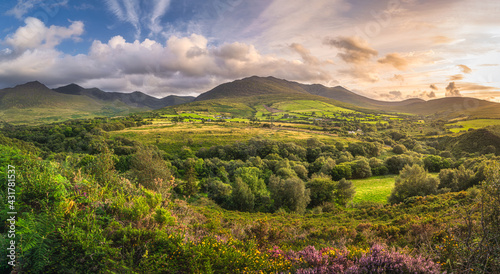 Large panorama with beautiful sunset, dramatic sky at the foothill of Carrauntoohil mountain, MacGillycuddys Reeks mountains, Ring of Kerry, Ireland
