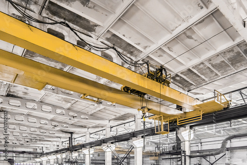 Overhead construction equipment crane in an industrial plant, background production workshop