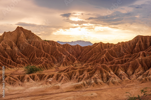 Desert Tatacoa - Desierto de la Tatacoa, Colombia. Amazing dry landcscape strewn with cacti during sunset, dramatic cloudy skies. Dry tropical forest. Parque Nacional Natural Los Nevados, Villavieja