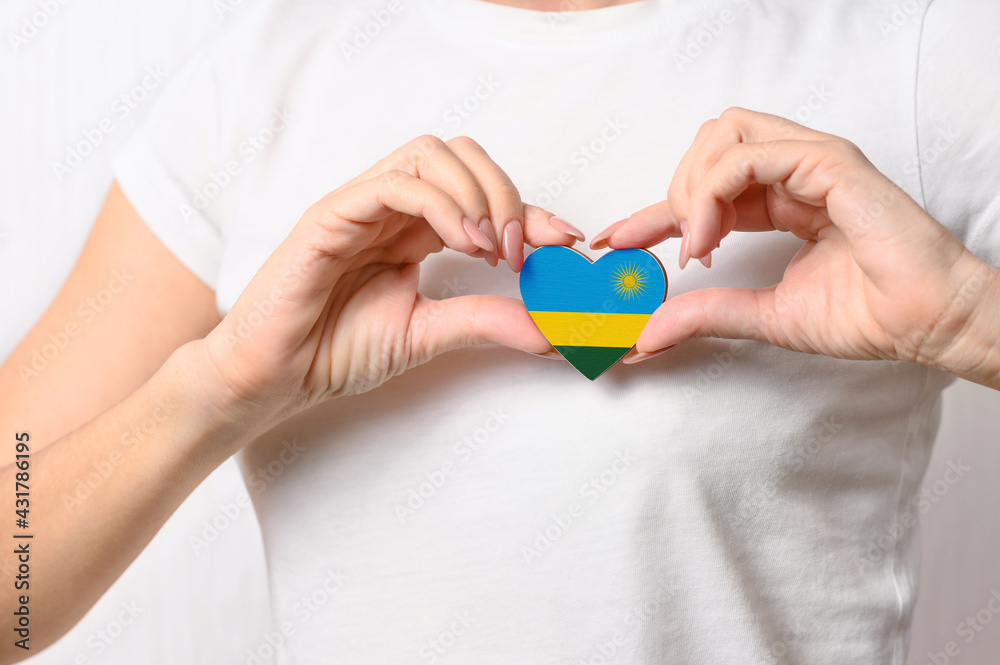Flag of Rwanda in the shape of a heart in the hands of a girl. Love Rwanda. Respect for Rwandans Flag of Rwanda in the shape of a heart in the hands of a girl. Love Rwanda. Respect for Rwandans