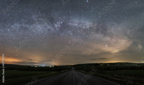 Suburban night highway, over the starry sky and the milky way