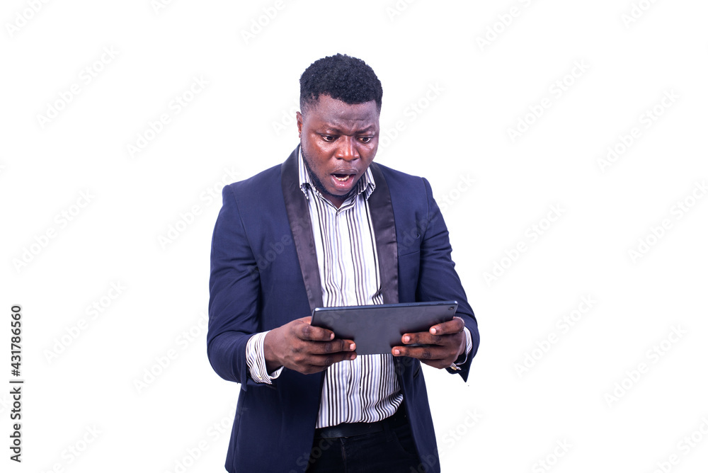 handsome young shocked businessman looking at digital tablet. handsome young shocked businessman looking at digital tablet.