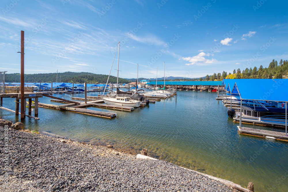 Boats docked in their slips at a lake marina near Blackwell Island on Lake Coeur d'Alene in the mountain resort town of Coeur d'Alene, Idaho USA