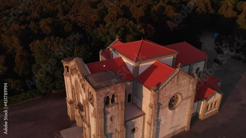 DRONE AERIAL FOOTAGE: Facade of the church of Nossa Senhora da Assuncao (Our Lady of Assumption) in the hill of Monte Cordoba at sunset in Santo Tirso, Portugal.  photo