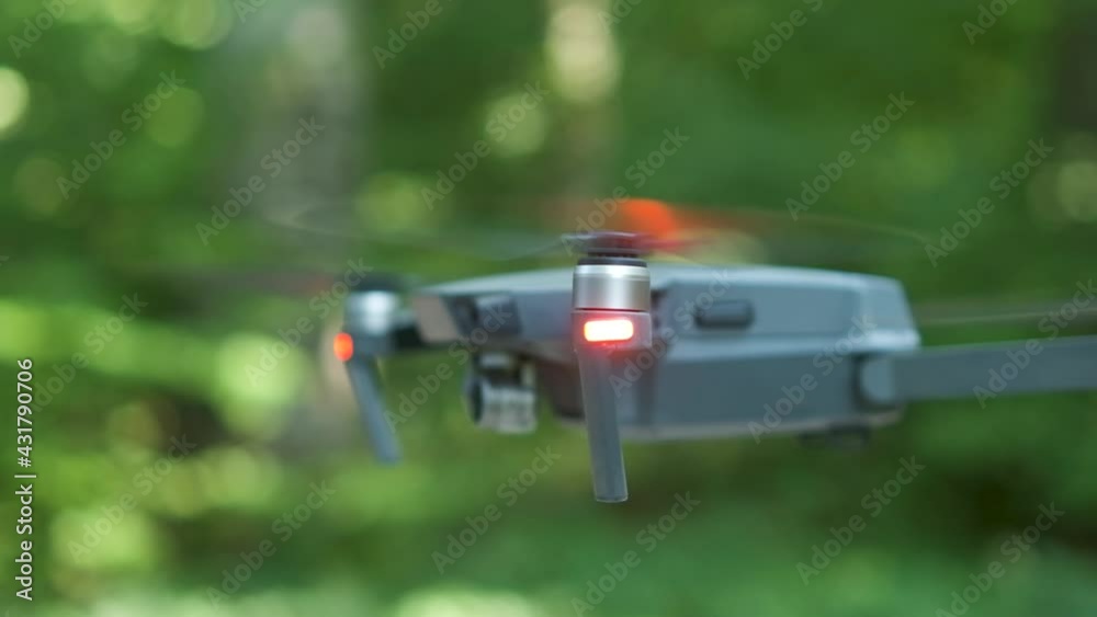 Drone copter with blurred propellers and video camera flying in air. Drone copter with blurred propellers and video camera flying in air.