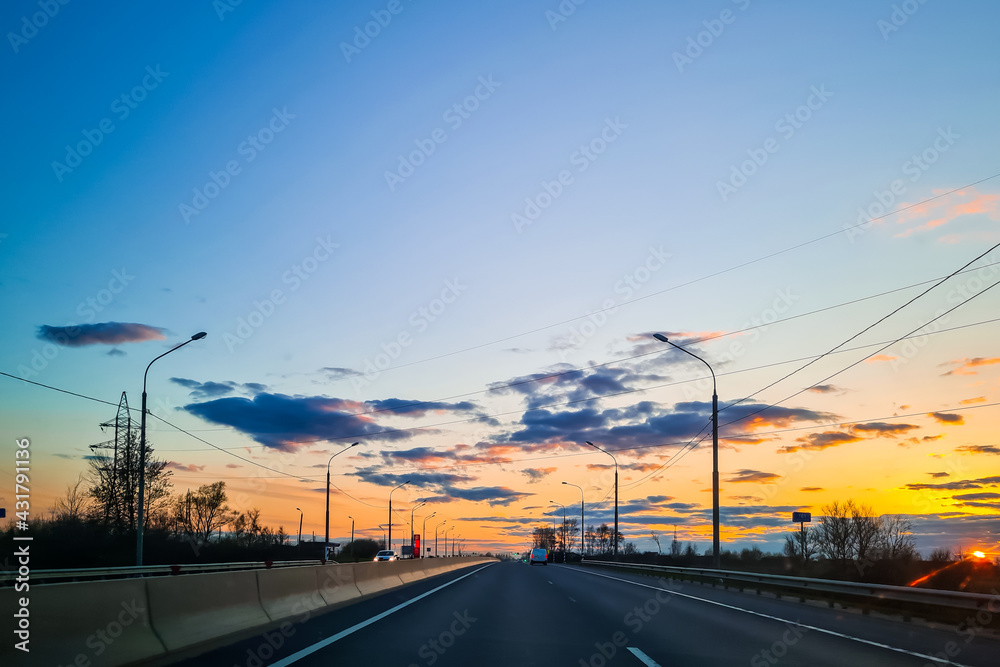 Highway at sunset. View of asphalt road from the car window.