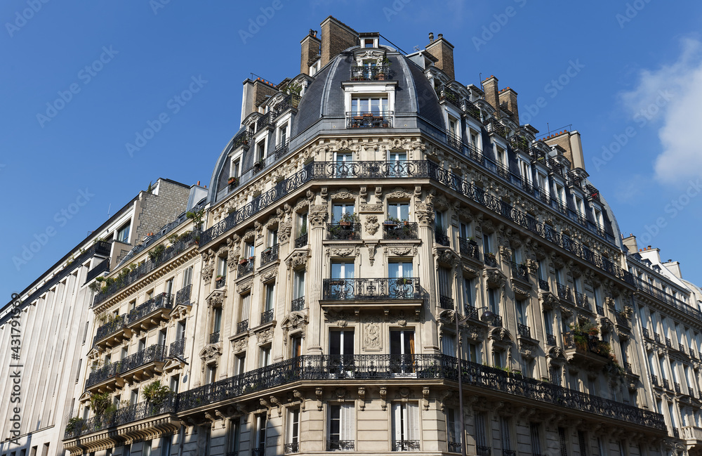 Traditional French house with typical balconies and windows. Paris.