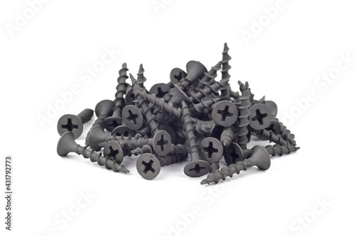 A slide of black self-tapping screws on gypsum plasterboard. Isolated on white background.