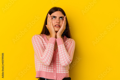 Young caucasian woman isolated on yellow background whining and crying disconsolately.