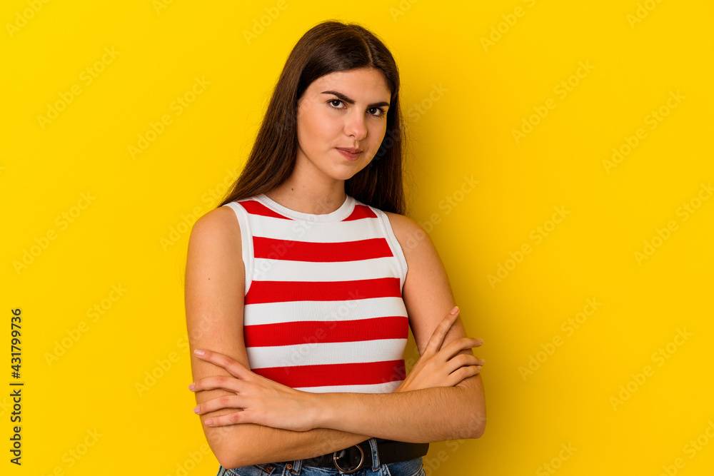Obraz premium Young caucasian woman isolated on yellow background unhappy looking in camera with sarcastic expression.