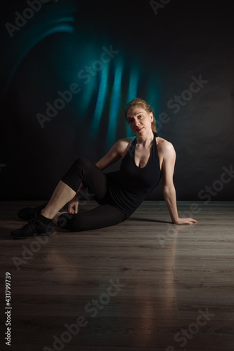 portrait of a dancer posing on the floor 