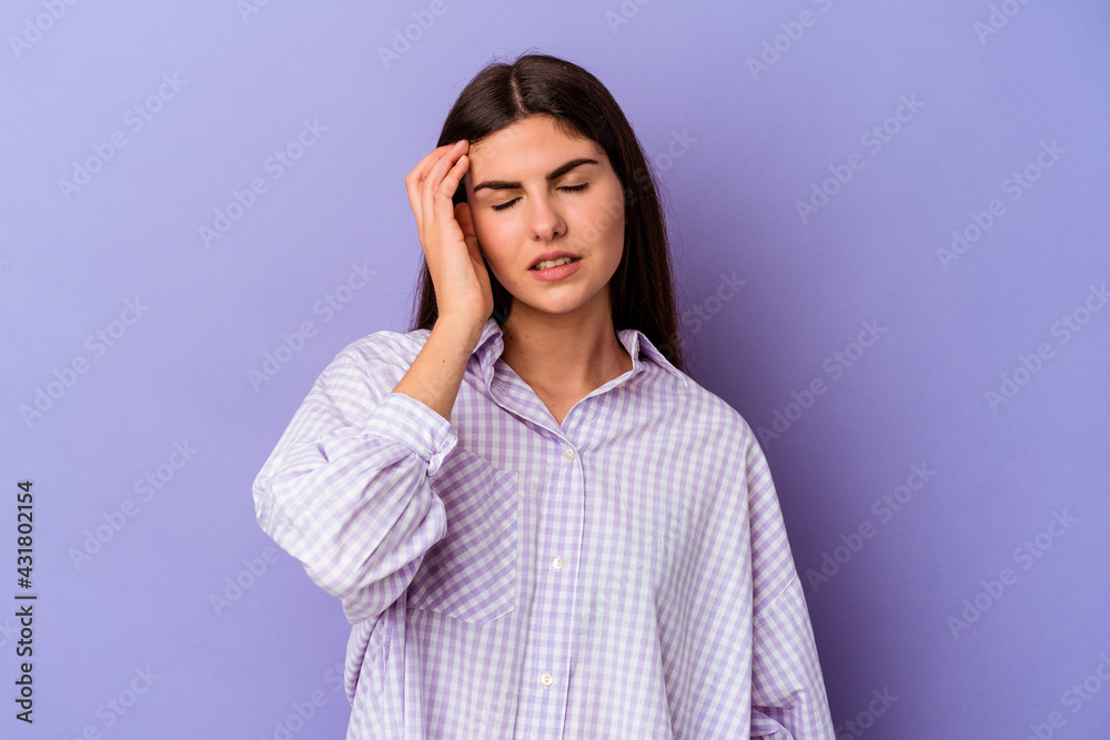 Young caucasian woman isolated on purple background tired and very sleepy keeping hand on head. Young caucasian woman isolated on purple background tired and very sleepy keeping hand on head.