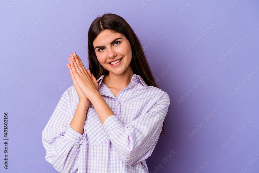 Young caucasian woman isolated on purple background feeling energetic and comfortable, rubbing hands confident. Young caucasian woman isolated on purple background feeling energetic and comfortable, rubbing hands confident.