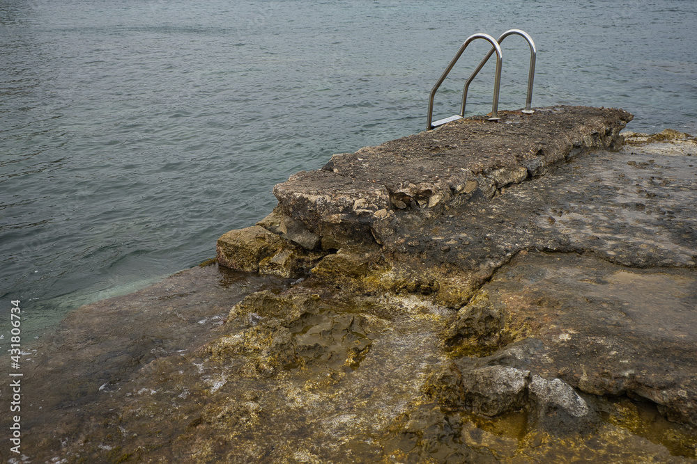 Fototapeta premium Concept of ladder in a natural pool