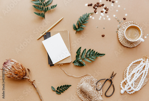 Stylish Female background with cup of coffee, necklace and blank note. Ideas, notes or plan writing concept. Top view. Flat lay. Minimal blogger, zero waste, eco friendly