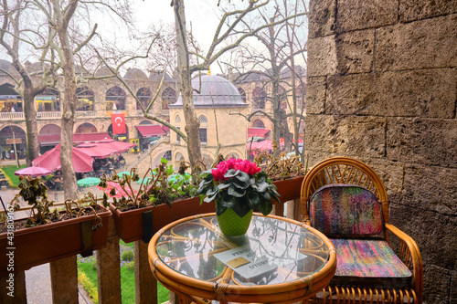 29.03.2021. Bursa. Turkey. Inside the kozahan in Bursa and vintage style table and armchair made of wooden and glass material and there is masjid inside the kozahan photo