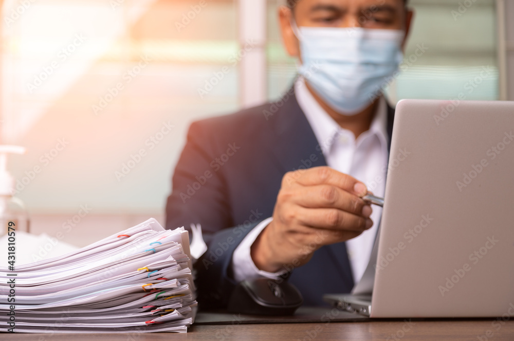 businessman in suit is seriously reading coronavirus cases. businessman in suit is seriously reading coronavirus cases.