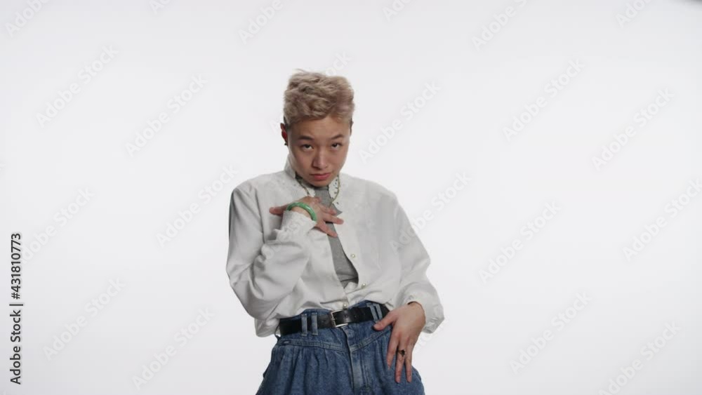 Young non-binary Asian person gestures who me? Young non-binary Asian person gestures who me?