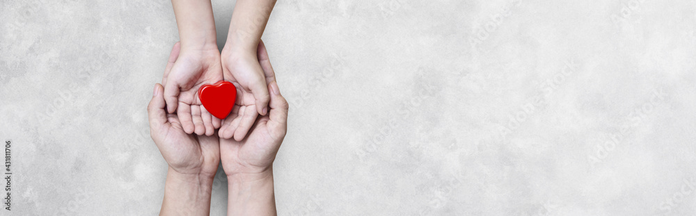 beautiful red heart on the hands of a child and his father Stock Photo ...