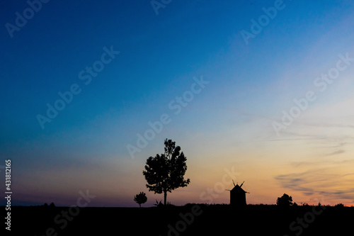an old windmill silhouette at sunset, windmills of Tes at sunset © Lea Digszammal