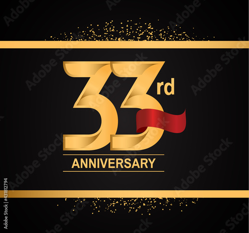 33 years anniversary logotype with premium gold color and red ribbon with glitter background isolated on black background. can be use for celebration and party