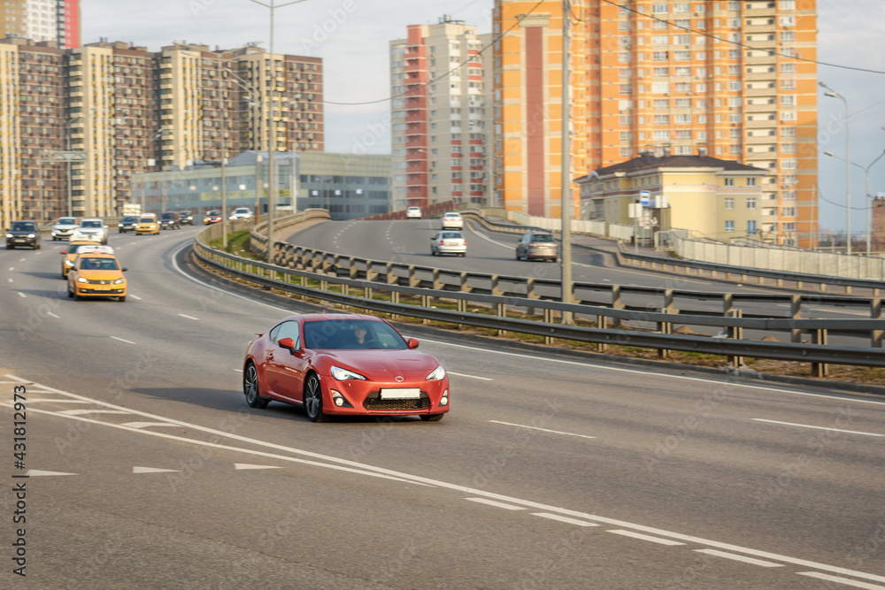 The car is driving on a high-speed wide highway. Behind you can see the multi-storey buildings of a large city The car is driving on a high-speed wide highway. Behind you can see the multi-storey buildings of a large city