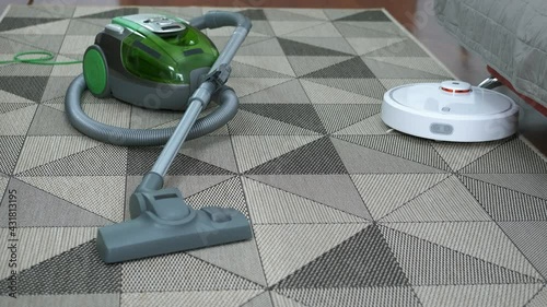 Hoover on the floor. A modern smart hoover clearn the dust on the floor. photo