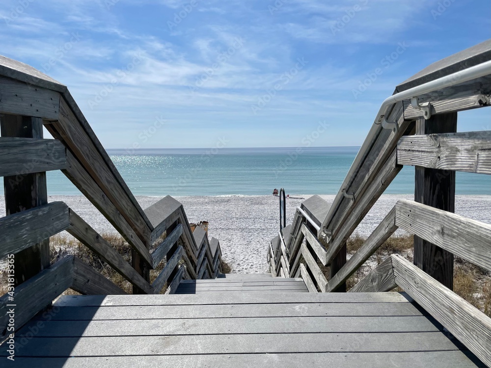 wooden bridge on Florida white sand beach 